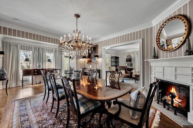 75 Green Hill Rd, Washington, CT 06793 - dining space featuring wallpapered walls, ornamental molding, a chandelier, wood finished floors, and a fireplace with flush hearth