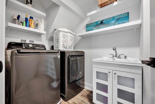 75 Green Hill Rd, Washington, CT 06793 - washroom with washer and dryer, light wood-style floors, and cabinet space
