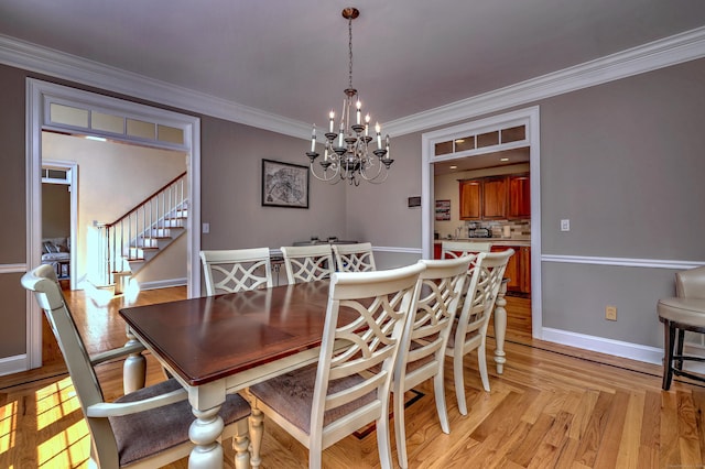 8 Dogwood Ct, Woodbridge, CT 06525 - dining area with a chandelier, ornamental molding, stairs, and light wood finished floors