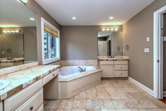 8 Dogwood Ct, Woodbridge, CT 06525 - full bath featuring two vanities, a garden tub, recessed lighting, and stone finish floors