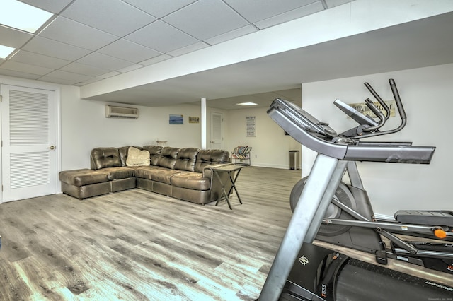 8 Dogwood Ct, Woodbridge, CT 06525 - exercise room with a wall mounted AC, wood finished floors, and a paneled ceiling