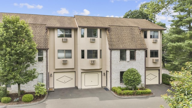 3 Radio Pl Unit 3, Stamford, CT 06906 - view of front of home with a shingled roof, brick siding, and an attached garage