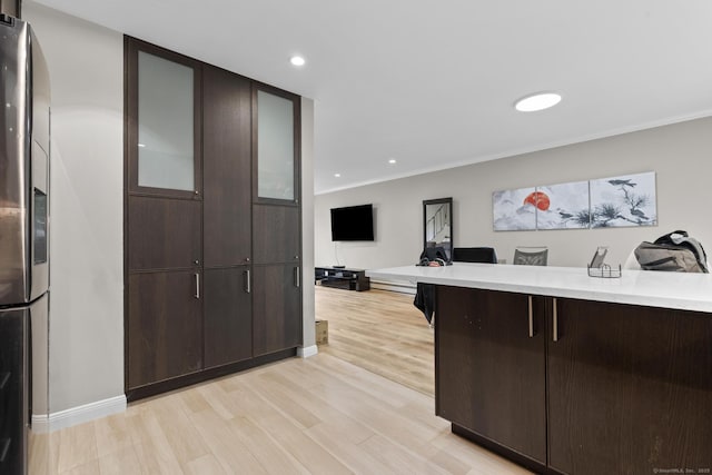 3 Radio Pl Unit 3, Stamford, CT 06906 - kitchen featuring stainless steel refrigerator with ice dispenser, dark brown cabinetry, light countertops, glass insert cabinets, and recessed lighting