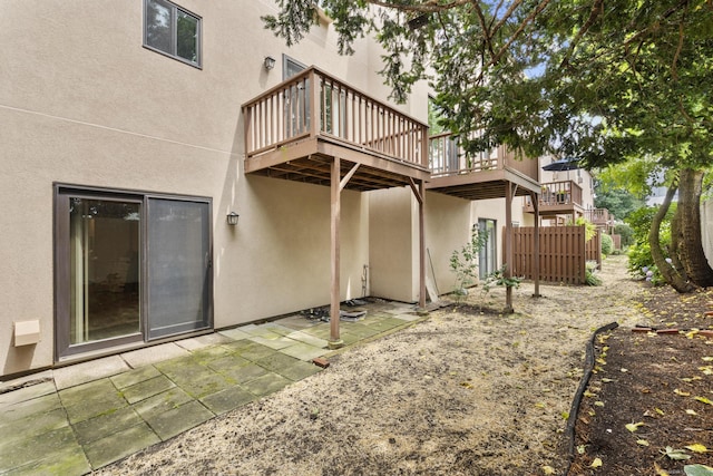 3 Radio Pl Unit 3, Stamford, CT 06906 - rear view of house with stucco siding, a wooden deck, and a patio