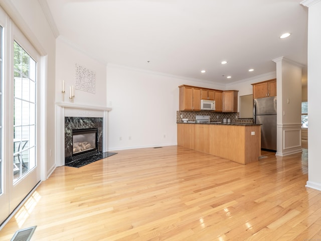 570 Danbury Rd Unit 14, Ridgefield, CT 06877 - kitchen with freestanding refrigerator, white microwave, plenty of natural light, open floor plan, and ornamental molding