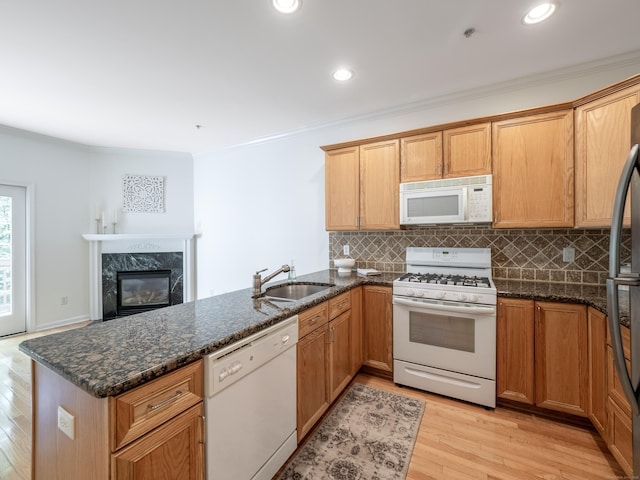 570 Danbury Rd Unit 14, Ridgefield, CT 06877 - kitchen featuring white appliances, a peninsula, backsplash, light wood-style flooring, and ornamental molding