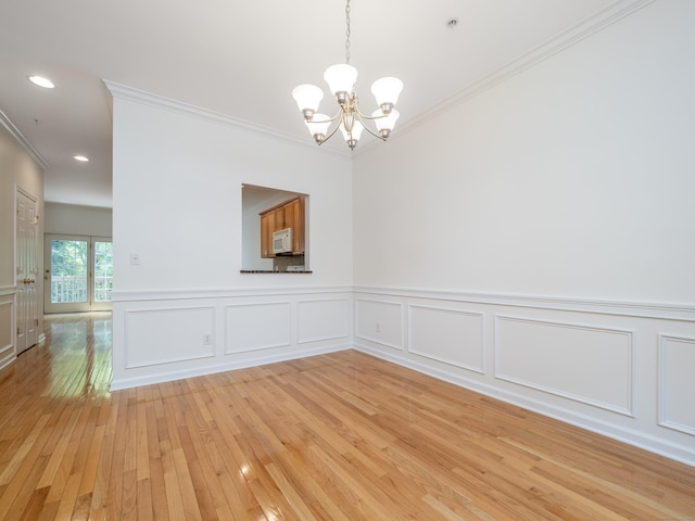570 Danbury Rd Unit 14, Ridgefield, CT 06877 - empty room featuring a chandelier, crown molding, light wood finished floors, wainscoting, and recessed lighting