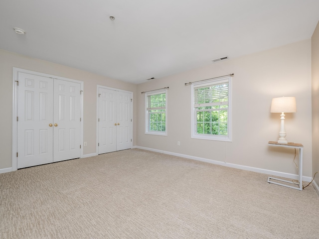 570 Danbury Rd Unit 14, Ridgefield, CT 06877 - unfurnished bedroom with two closets and carpet