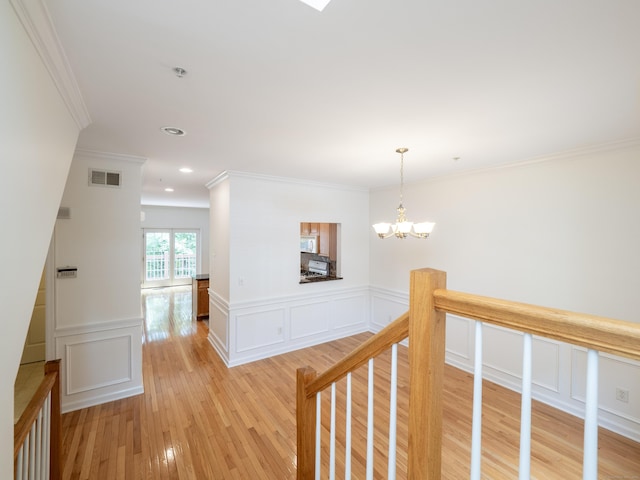 570 Danbury Rd Unit 14, Ridgefield, CT 06877 - corridor with light wood-style floors, a chandelier, ornamental molding, a wainscoted wall, and recessed lighting