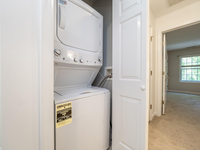 570 Danbury Rd Unit 14, Ridgefield, CT 06877 - laundry room with stacked washing machine and dryer and light carpet