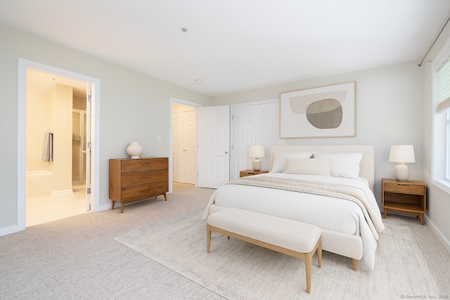 570 Danbury Rd Unit 14, Ridgefield, CT 06877 - bedroom with light colored carpet, connected bathroom, and a closet