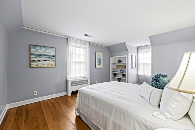 29 Boswell Rd, West Hartford, CT 06107 - bedroom with radiator heating unit, vaulted ceiling, multiple windows, and wood finished floors