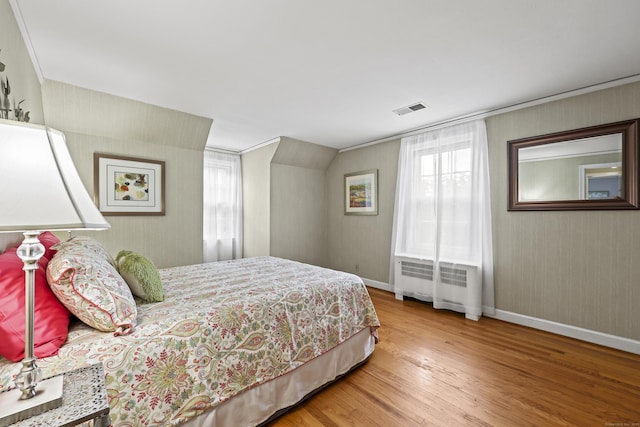 29 Boswell Rd, West Hartford, CT 06107 - bedroom with radiator heating unit, wood finished floors, and multiple windows