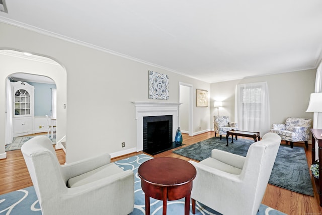 29 Boswell Rd, West Hartford, CT 06107 - living area featuring wood finished floors, ornamental molding, a brick fireplace, and arched walkways