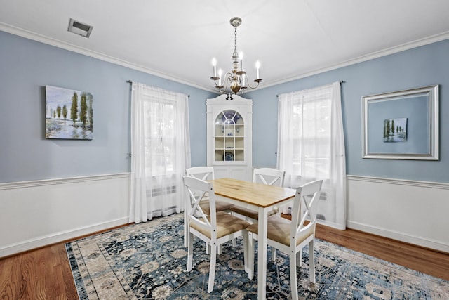29 Boswell Rd, West Hartford, CT 06107 - dining room with a chandelier, wood finished floors, ornamental molding, and wainscoting
