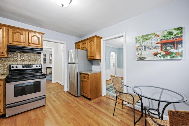 29 Boswell Rd, West Hartford, CT 06107 - kitchen featuring stainless steel appliances, under cabinet range hood, brown cabinets, light wood finished floors, and tasteful backsplash