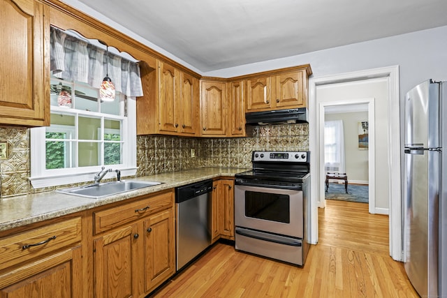 29 Boswell Rd, West Hartford, CT 06107 - kitchen featuring stainless steel appliances, under cabinet range hood, tasteful backsplash, light wood-style floors, and brown cabinetry