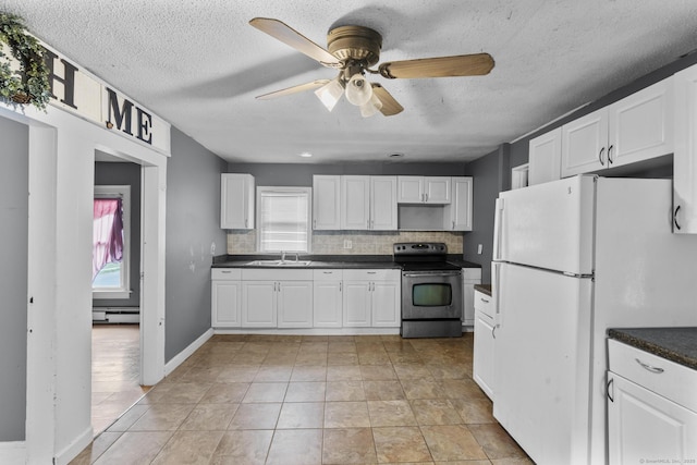 104 Greenwood St, New Britain, CT 06051 - kitchen featuring stainless steel electric range oven, freestanding refrigerator, a baseboard radiator, dark countertops, and plenty of natural light