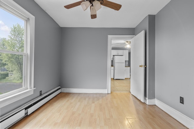 104 Greenwood St, New Britain, CT 06051 - spare room featuring baseboard heating, a ceiling fan, and light wood-type flooring