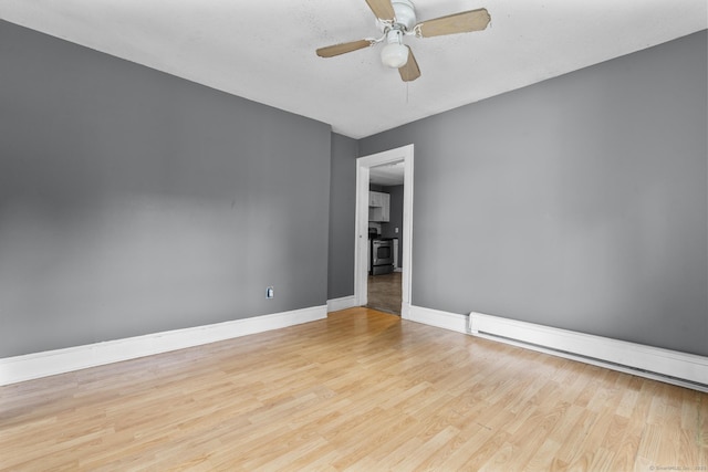 104 Greenwood St, New Britain, CT 06051 - unfurnished room featuring a baseboard radiator, wood finished floors, and a ceiling fan