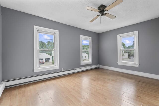 104 Greenwood St, New Britain, CT 06051 - unfurnished room with a baseboard radiator, plenty of natural light, a textured ceiling, wood finished floors, and ceiling fan