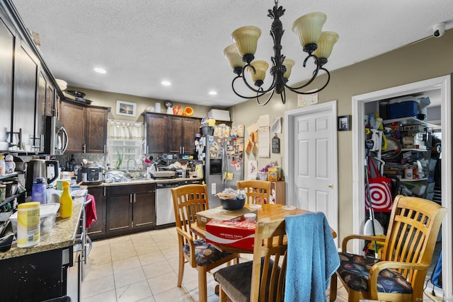 104 Greenwood St, New Britain, CT 06051 - kitchen featuring stainless steel appliances, dark brown cabinetry, light tile patterned floors, a chandelier, and a textured ceiling
