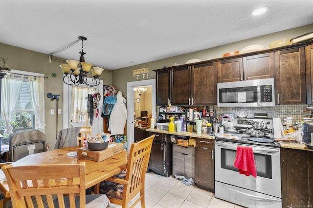 104 Greenwood St, New Britain, CT 06051 - kitchen with appliances with stainless steel finishes, a chandelier, dark brown cabinets, light tile patterned flooring, and backsplash
