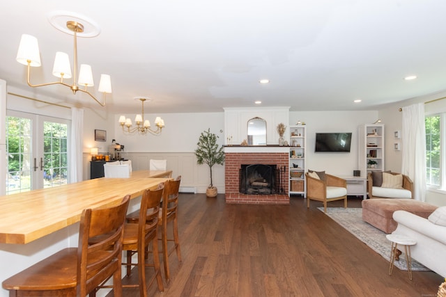 34 Taft St, Killingly, CT 06239 - dining space featuring a chandelier, dark wood-type flooring, a fireplace, and recessed lighting