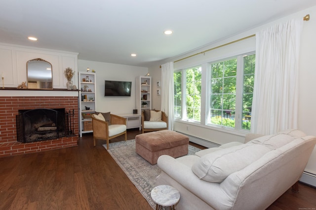 34 Taft St, Killingly, CT 06239 - living area with baseboard heating, dark wood finished floors, recessed lighting, and a brick fireplace
