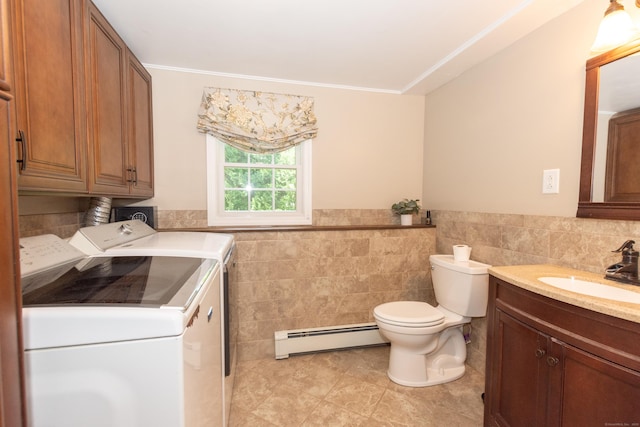 34 Taft St, Killingly, CT 06239 - bathroom with a baseboard heating unit, washing machine and dryer, tile walls, vanity, and tile patterned floors