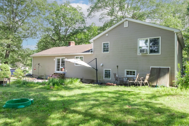 34 Taft St, Killingly, CT 06239 - rear view of house with a lawn and a chimney