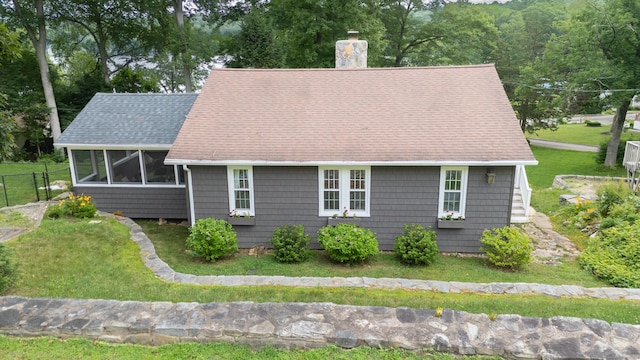 56 Wildwood Rd, East Haddam, CT 06423 - view of front of property featuring a chimney, a sunroom, and roof with shingles