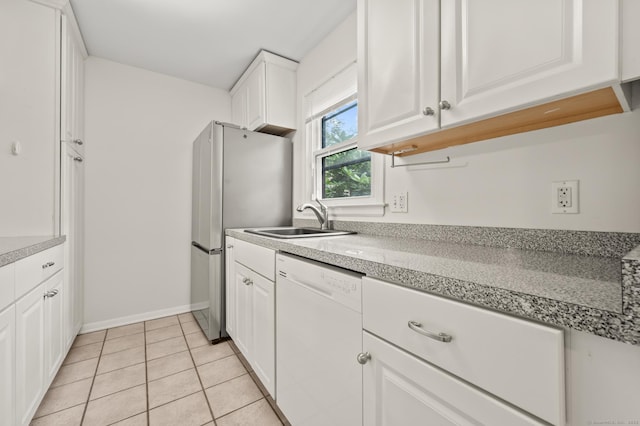 11 Danforth Ln Unit 11, Rocky Hill, CT 06067 - kitchen with white dishwasher, freestanding refrigerator, and white cabinets