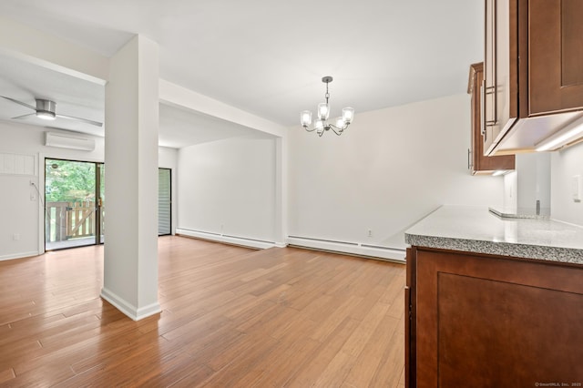 11 Danforth Ln Unit 11, Rocky Hill, CT 06067 - kitchen with baseboard heating, an AC wall unit, and light wood-type flooring