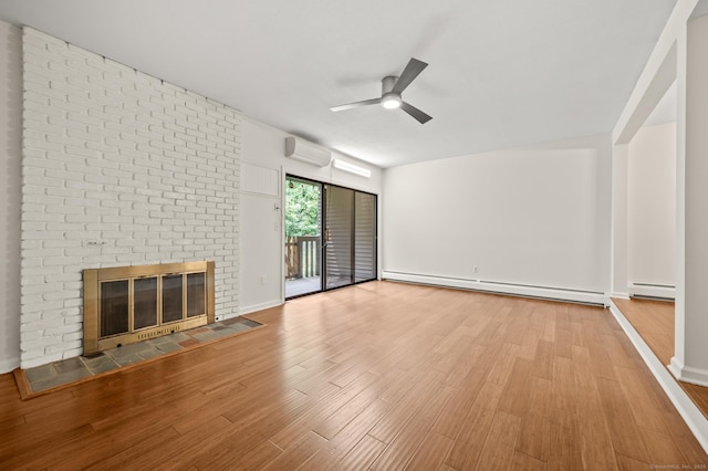 11 Danforth Ln Unit 11, Rocky Hill, CT 06067 - unfurnished living room with a baseboard heating unit, a wall mounted AC, a ceiling fan, wood finished floors, and a brick fireplace