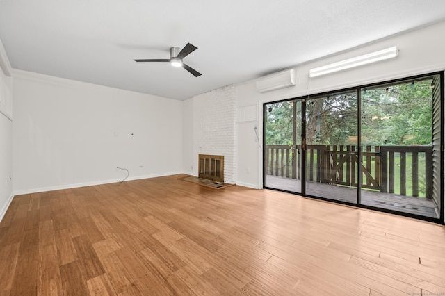 11 Danforth Ln Unit 11, Rocky Hill, CT 06067 - unfurnished living room featuring a wall unit AC, wood finished floors, a ceiling fan, and a fireplace