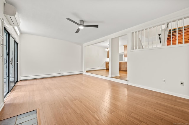 11 Danforth Ln Unit 11, Rocky Hill, CT 06067 - empty room with a wall unit AC, a baseboard radiator, a baseboard heating unit, light wood-style floors, and ceiling fan