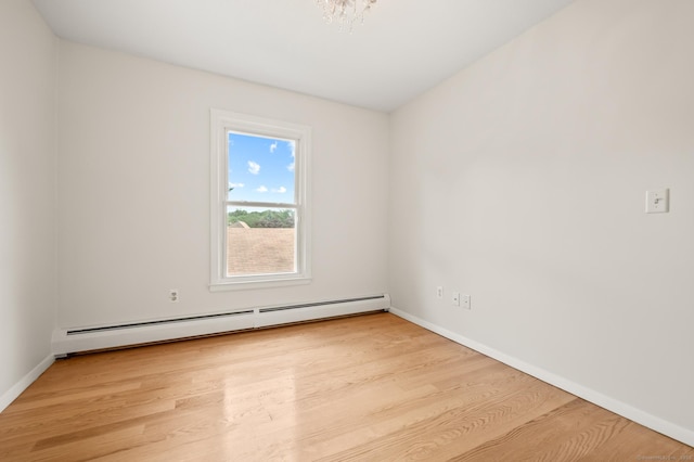 11 Danforth Ln Unit 11, Rocky Hill, CT 06067 - spare room featuring a baseboard heating unit, wood finished floors, and a chandelier