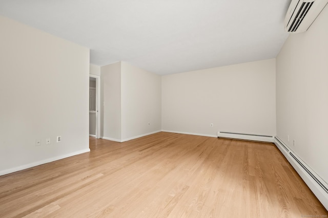 11 Danforth Ln Unit 11, Rocky Hill, CT 06067 - spare room with a wall unit AC, baseboard heating, and light wood-style floors