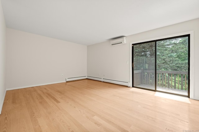 11 Danforth Ln Unit 11, Rocky Hill, CT 06067 - spare room featuring a wall unit AC, baseboard heating, and wood finished floors