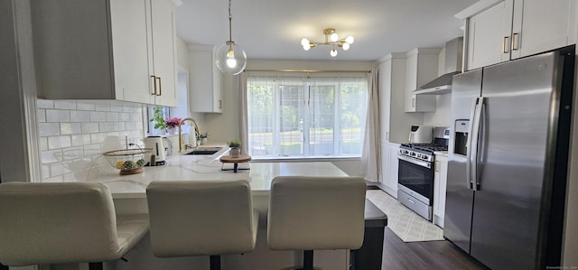 187 Two Rod Hwy, Wethersfield, CT 06109 - kitchen featuring stainless steel appliances, wall chimney exhaust hood, a peninsula, dark wood-style floors, and white cabinets