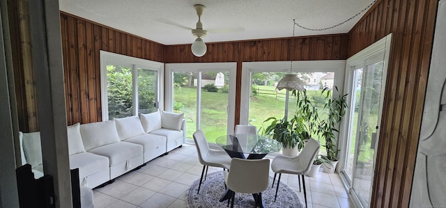 187 Two Rod Hwy, Wethersfield, CT 06109 - sunroom featuring wooden walls, a textured ceiling, and tile patterned flooring