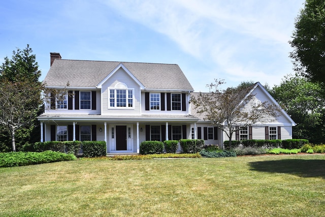 32 Sable Dr, Ledyard, CT 06339 - colonial home featuring a chimney, a front lawn, and a porch