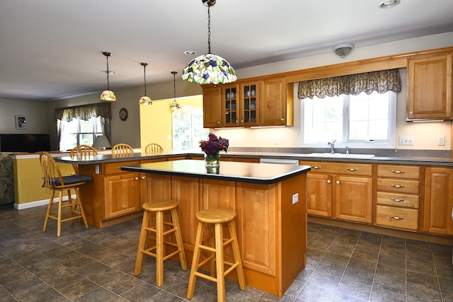 32 Sable Dr, Ledyard, CT 06339 - kitchen with a kitchen bar, brown cabinets, a kitchen island, and recessed lighting