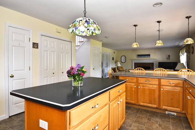 32 Sable Dr, Ledyard, CT 06339 - kitchen with dark countertops, a fireplace, a center island, and open floor plan
