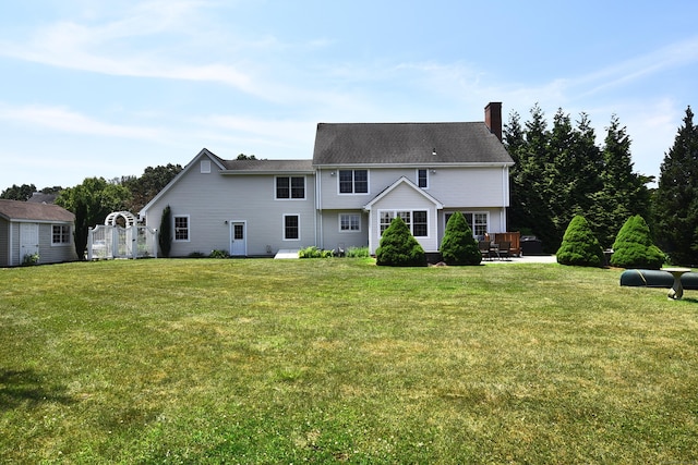 32 Sable Dr, Ledyard, CT 06339 - back of house with a yard, a chimney, a patio area, and a storage unit
