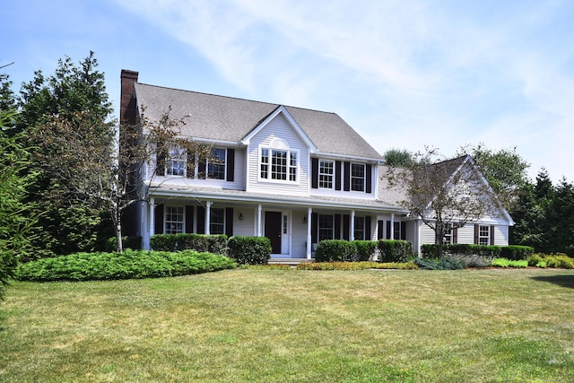 32 Sable Dr, Ledyard, CT 06339 - colonial house featuring a chimney, a front yard, and a porch