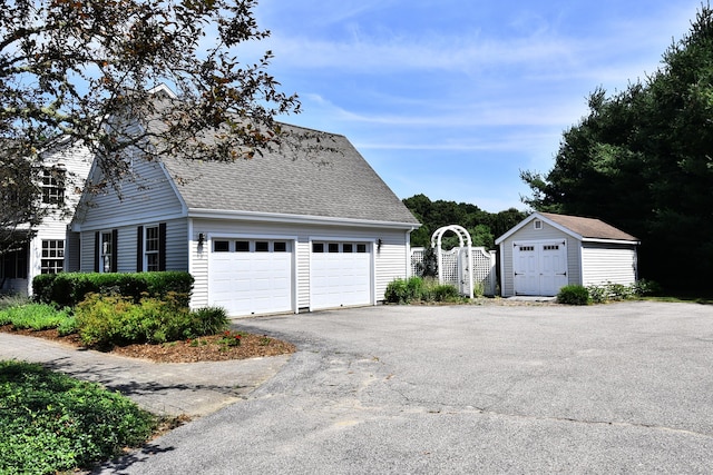 32 Sable Dr, Ledyard, CT 06339 - view of home's exterior with roof with shingles, a shed, driveway, and a garage