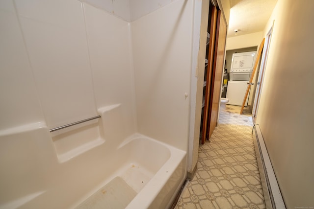 226 Laurel St Apt 4, East Haven, CT 06512 - bathroom with stacked washing machine and dryer, a baseboard heating unit, and shower / washtub combination