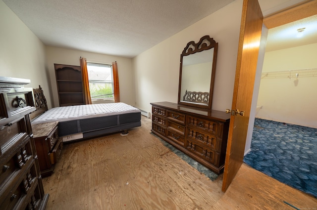 226 Laurel St Apt 4, East Haven, CT 06512 - bedroom featuring wood finished floors and a textured ceiling